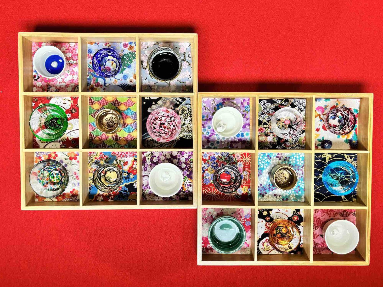Nine sake cups arranged in a wooden tasting tray